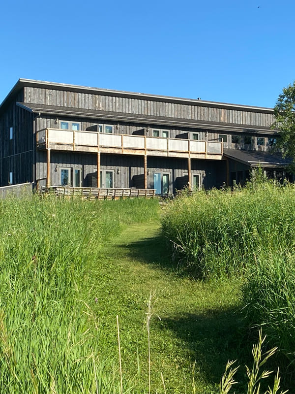 Grey washed lodge with decks at Waters Edge Eco Lodge